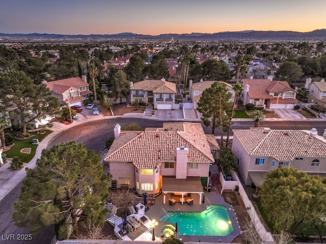 aerial view at dusk featuring a mountain view