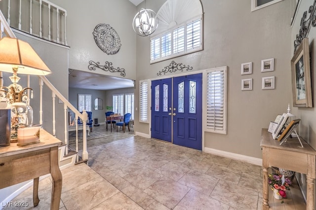 entrance foyer with a high ceiling and a notable chandelier