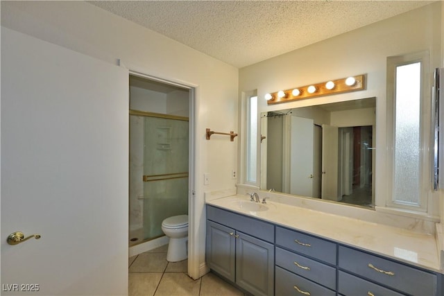 bathroom with tile patterned flooring, vanity, walk in shower, toilet, and a textured ceiling