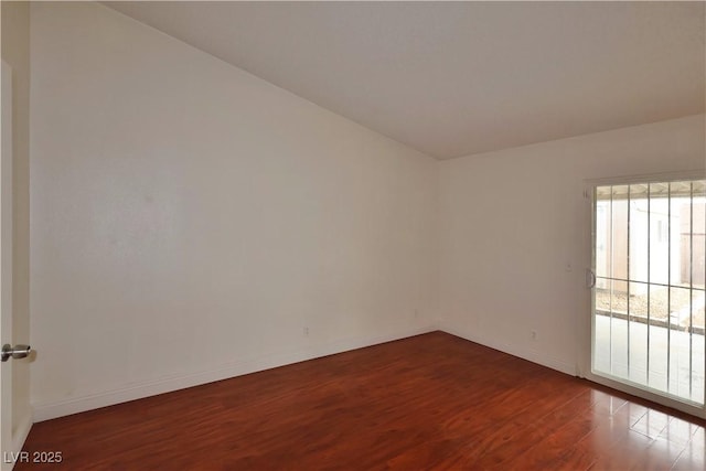 spare room with dark wood-type flooring