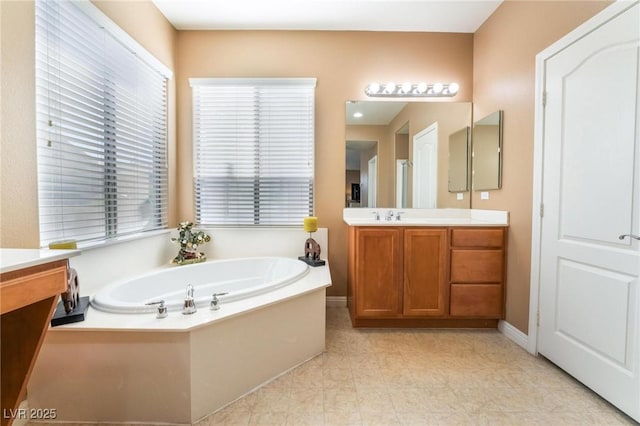 bathroom with a bath and vanity