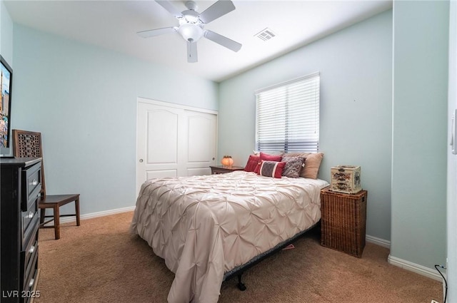 carpeted bedroom featuring ceiling fan and a closet