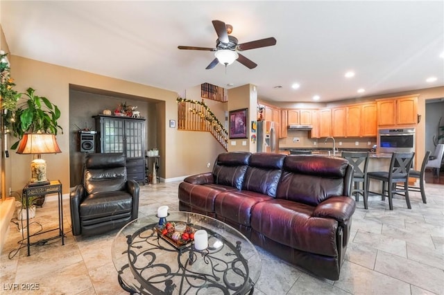 living room with ceiling fan and sink