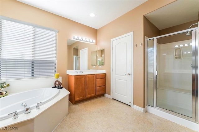 bathroom with independent shower and bath and vanity