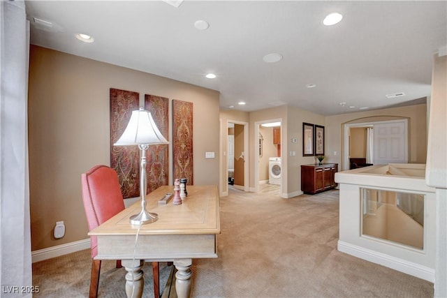 dining room featuring washer / clothes dryer and light colored carpet