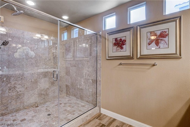 bathroom with hardwood / wood-style floors and a shower with shower door