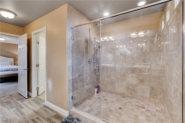 bathroom featuring an enclosed shower and hardwood / wood-style floors