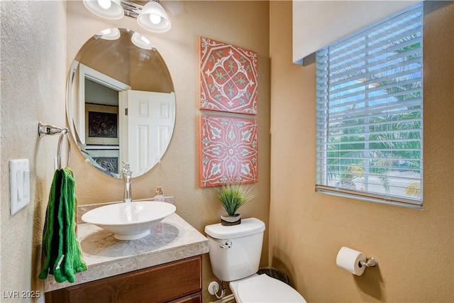 bathroom featuring toilet and vanity