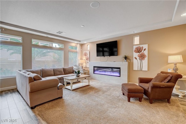 living room featuring a tile fireplace