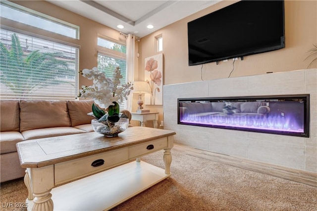 living room with a fireplace and carpet floors