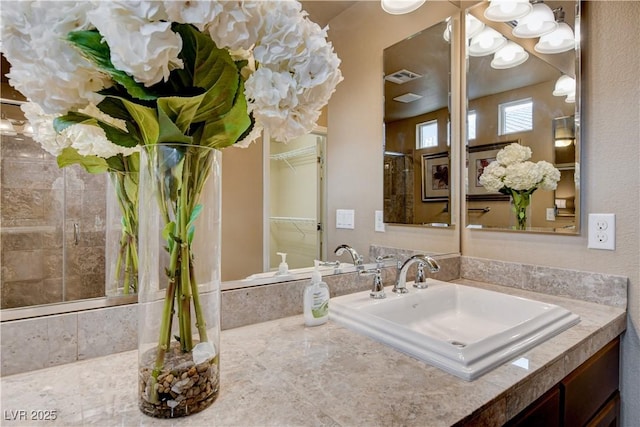 bathroom with sink and a shower with shower door