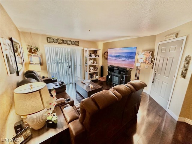 living room with a textured ceiling and a fireplace