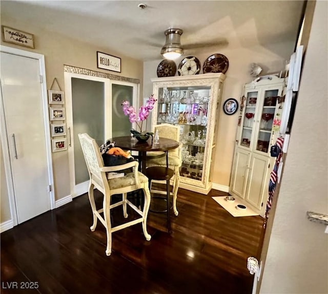 dining area featuring ceiling fan and dark hardwood / wood-style floors