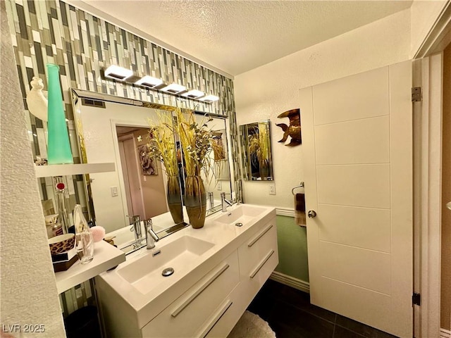 bathroom featuring a textured ceiling, tile patterned floors, and vanity