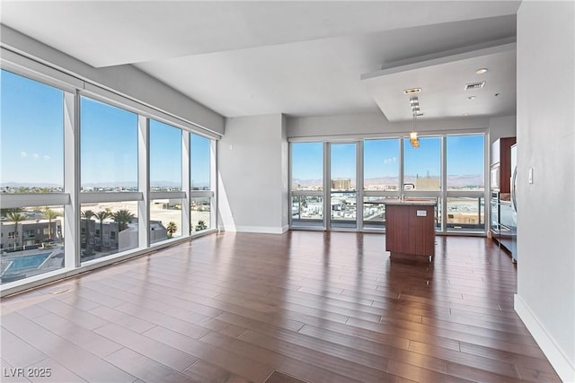 unfurnished living room featuring dark hardwood / wood-style flooring