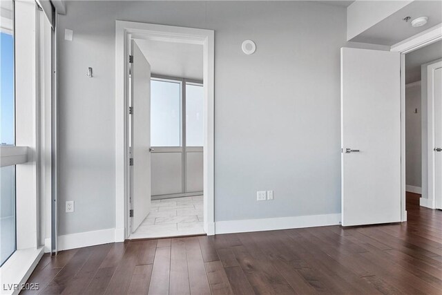 unfurnished bedroom with dark wood-type flooring