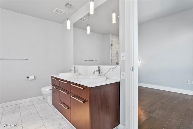 bathroom featuring toilet and vanity