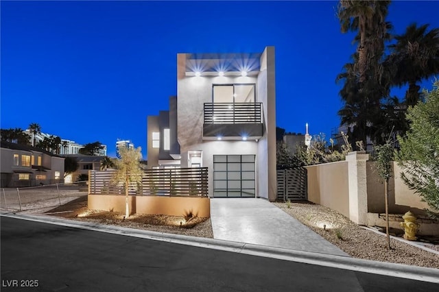 modern home with a balcony and a garage