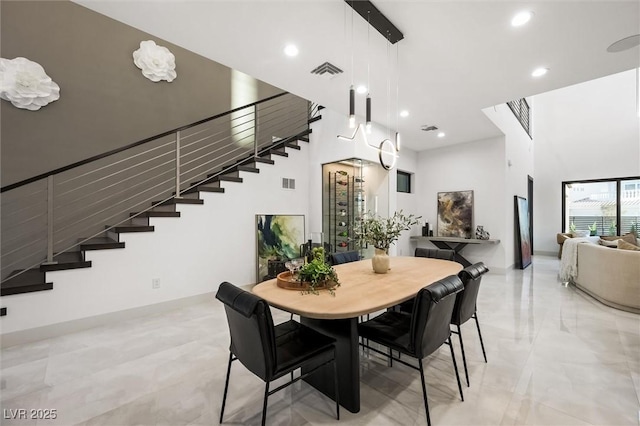 dining space featuring a high ceiling