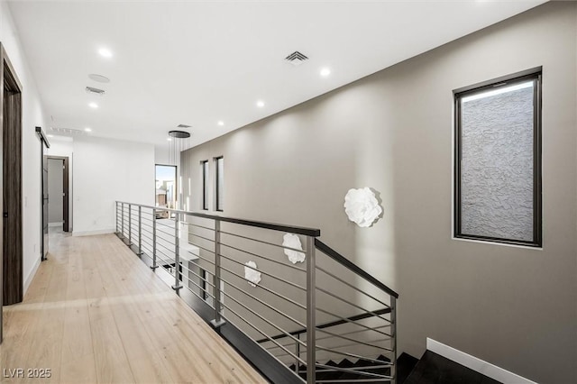 hall with light hardwood / wood-style floors