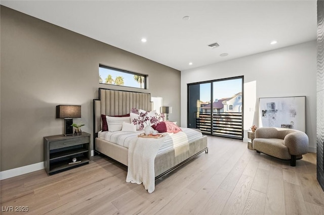 bedroom with light hardwood / wood-style flooring and multiple windows