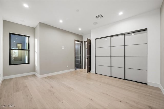 unfurnished bedroom featuring light wood-type flooring