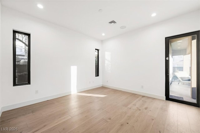 unfurnished room with light hardwood / wood-style floors and a healthy amount of sunlight