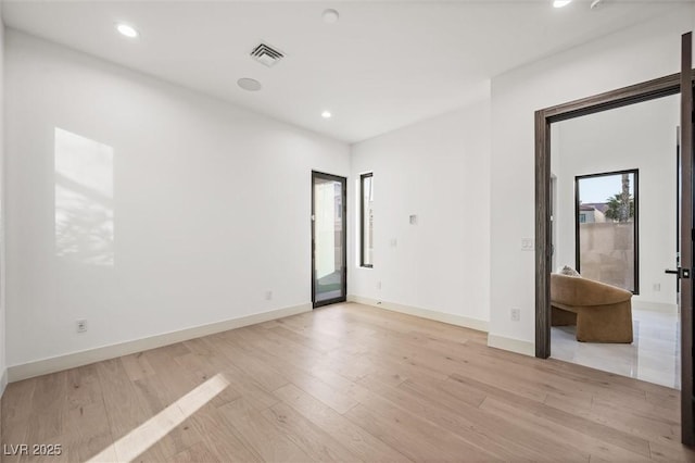 spare room featuring light wood-type flooring