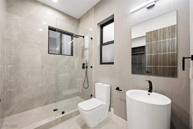 bathroom with tile walls, toilet, and tiled shower