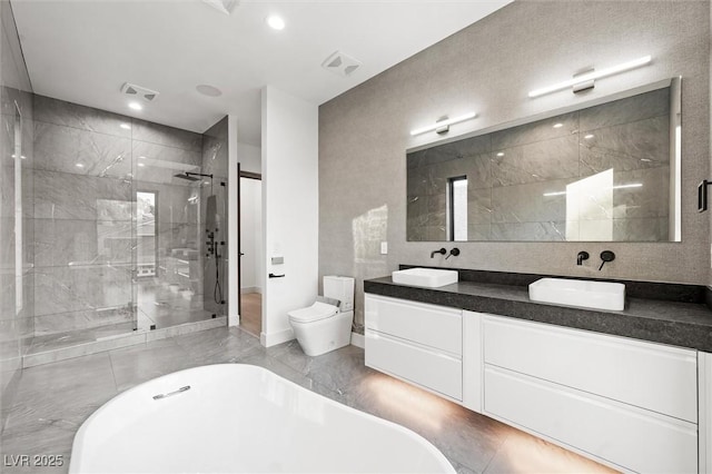 full bathroom featuring toilet, shower with separate bathtub, and vanity