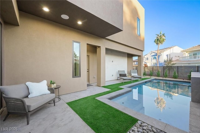 view of pool with an outdoor living space and a patio