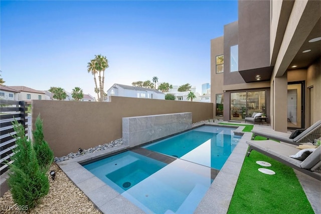 view of swimming pool featuring a patio area and an in ground hot tub