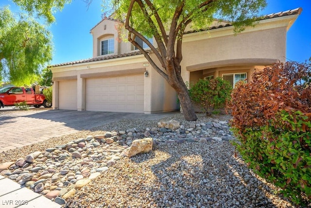 mediterranean / spanish house featuring a garage