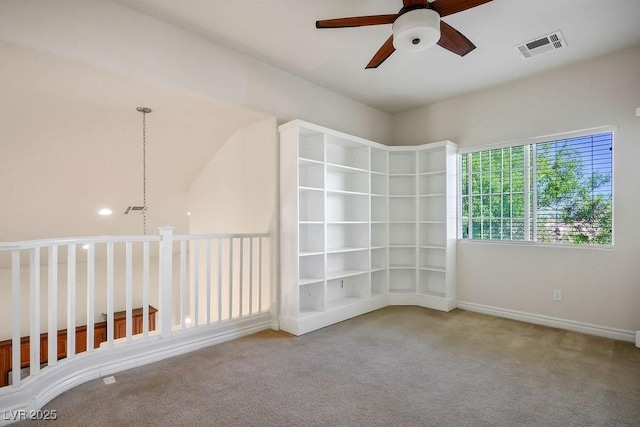 unfurnished room with light carpet and ceiling fan