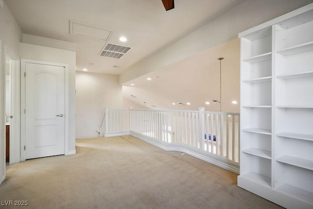 unfurnished room featuring light colored carpet