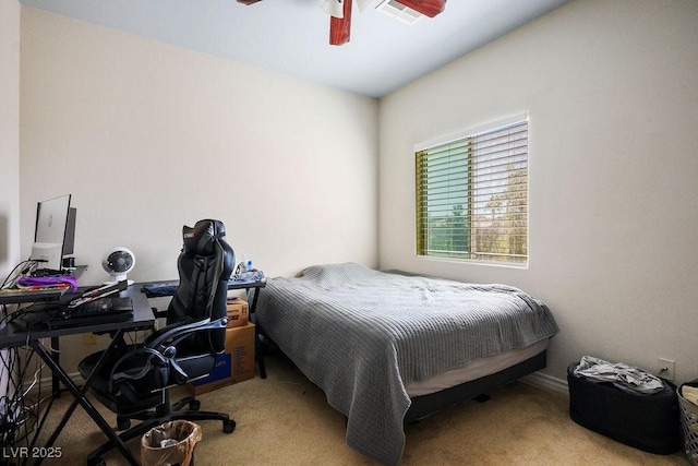 bedroom with ceiling fan and light carpet