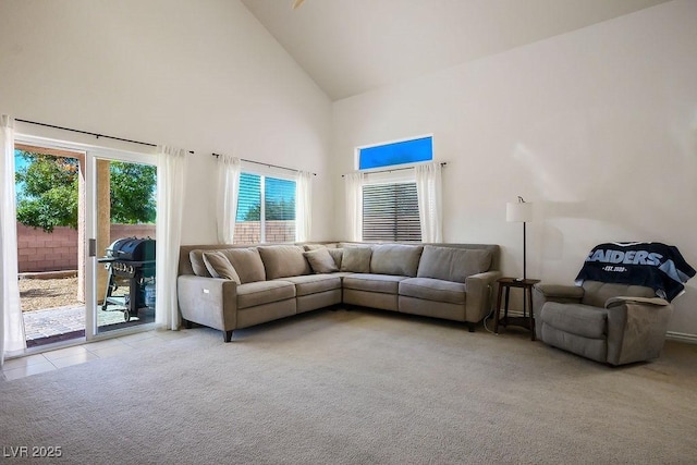 living room featuring light carpet and high vaulted ceiling