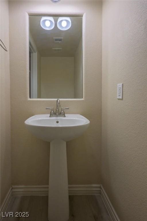 bathroom featuring wood-type flooring and sink