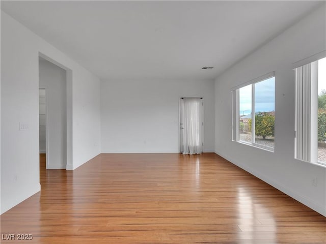 empty room with light hardwood / wood-style flooring