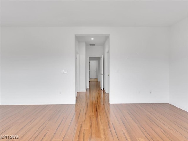 spare room featuring light wood-type flooring