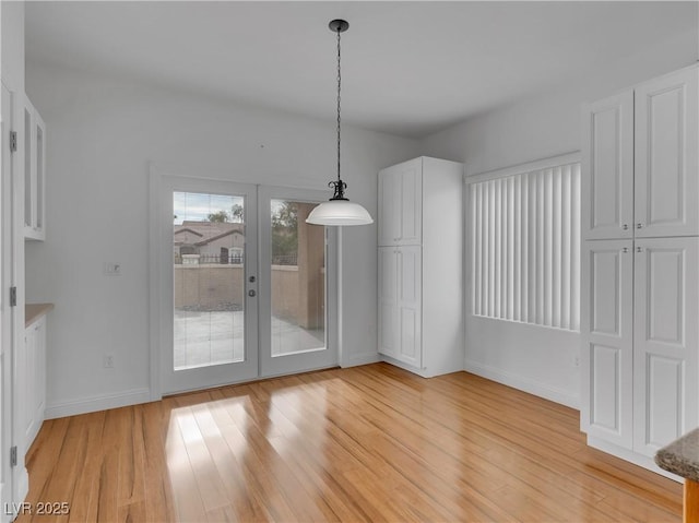 unfurnished dining area with light hardwood / wood-style flooring