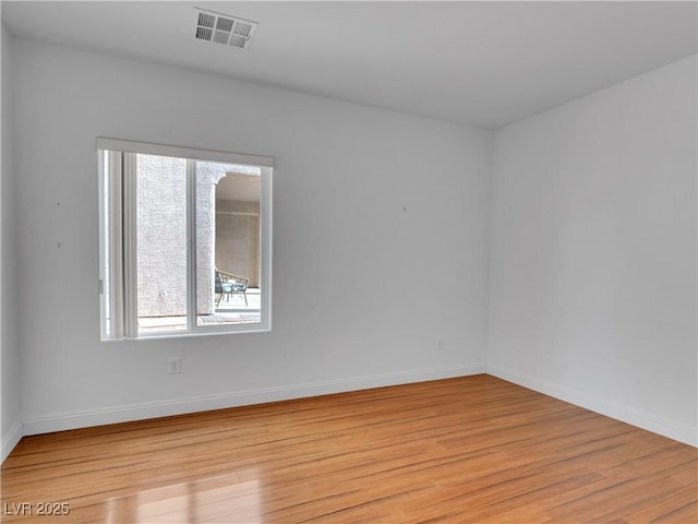 empty room featuring light hardwood / wood-style flooring and a wealth of natural light