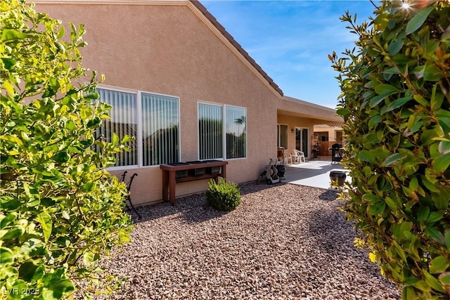 view of side of property with a patio area