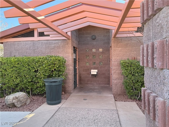 property entrance with a pergola