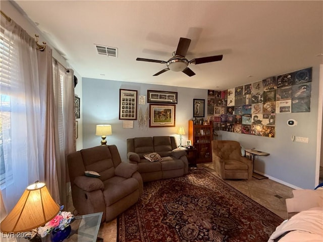 living room with ceiling fan and tile patterned floors