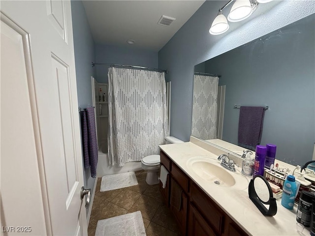 full bathroom with toilet, tile patterned floors, vanity, and shower / tub combo