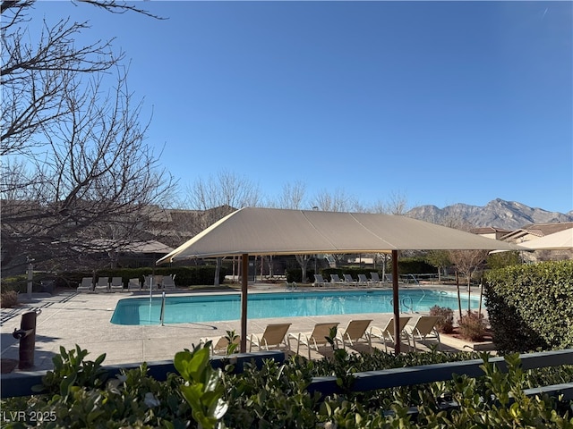 view of pool featuring a mountain view and a patio