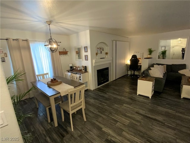 dining area featuring a chandelier and dark wood-type flooring