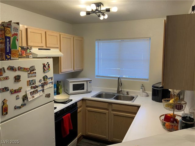 kitchen featuring white appliances, a chandelier, sink, and light brown cabinets