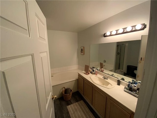 bathroom with vanity and a bath